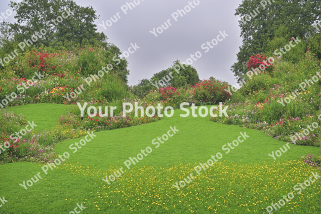 Stock Photo of Big garden of flowers and trees overcast day