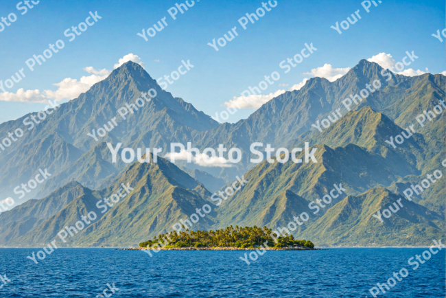 Stock Photo of Island on the ocean with big mountain in the background tropical