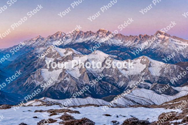 Stock Photo of Snowy mountains at sunset at altitude