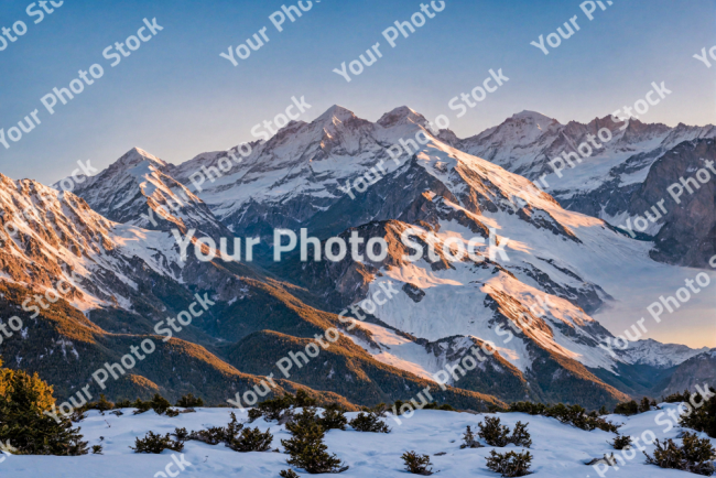 Stock Photo of Snowy mountains at sunset at altitude