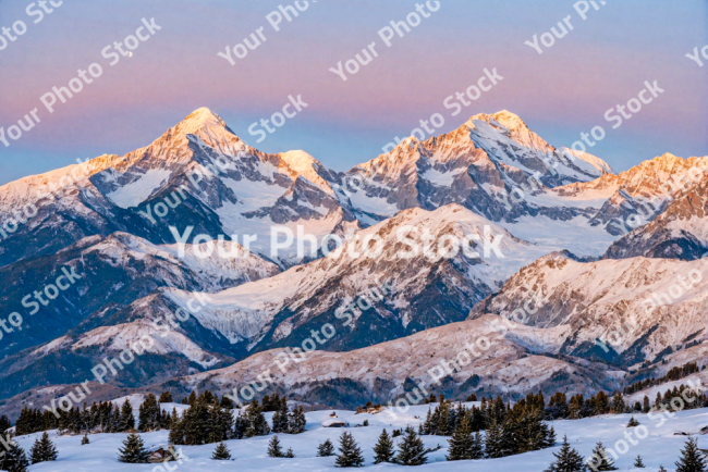 Stock Photo of Landscape of snowy mountains at dusk