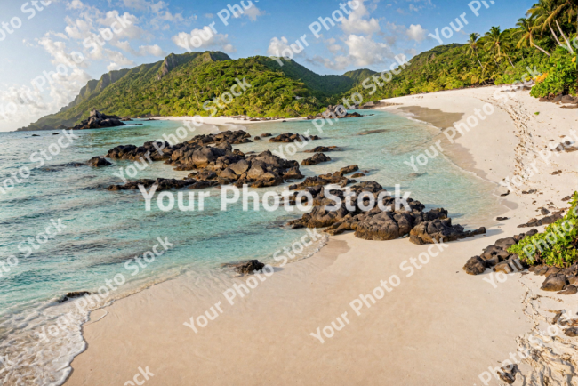 Stock Photo of Tropical paradise beach with rocks at day