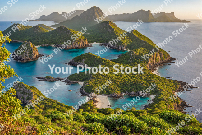 Stock Photo of Tropical island and sunset from the ocean