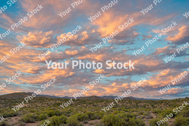 Stock Photo of Landscape sunset with orange clouds in the sky