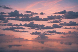 Stock Photo of Sunset clouds on the sea orange pink relaxing zen