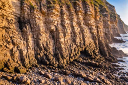 Stock Photo of Cliff rocks sea ocean sunset