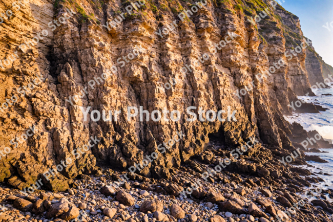 Stock Photo of Cliff rocks sea ocean sunset