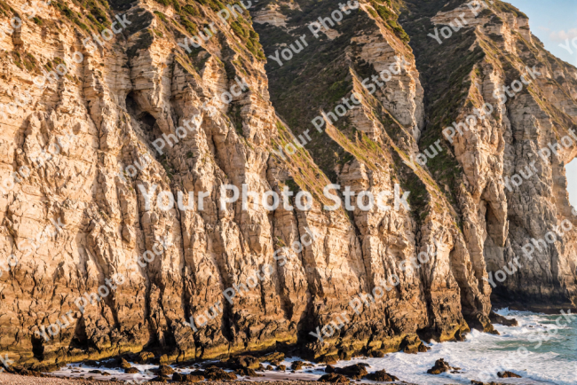 Stock Photo of Cliffs rocks coast sunset