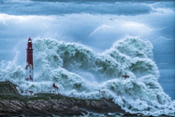Stock Photo of Storm hurrican with lighthouse and the sea ocean