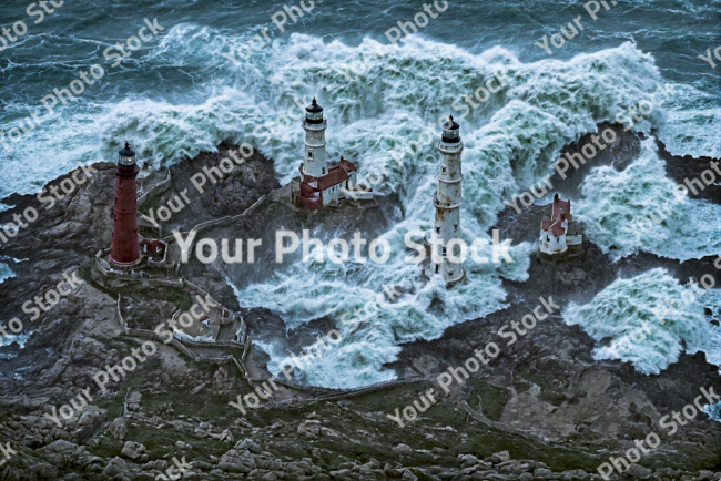 Stock Photo of Lighthouses in the rocks and storm ocean sea