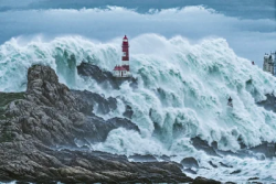 Stock Photo of Ocean sea hurrican lighthouse rock in the storm
